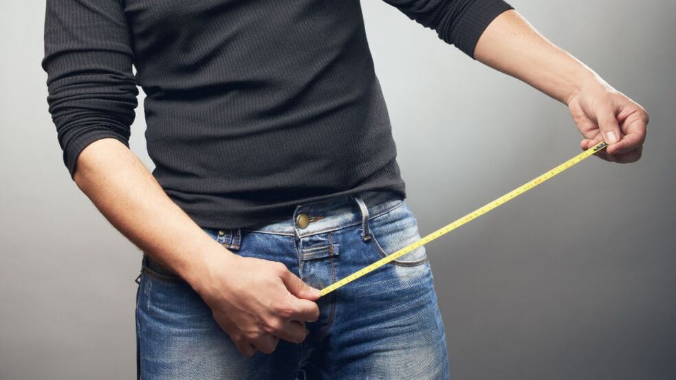 A man with a ruler measures a member